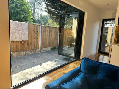 a living room with a couch and a sliding glass door at Scotney Retreat in Moffat