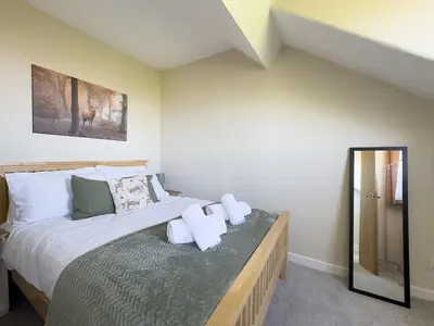 a bedroom with a bed with towels on it at Spacious 4-Bed Lake District Getaway for Groups in Mealsgate