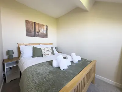 a bedroom with a bed with towels on it at Spacious 4-Bed Lake District Getaway for Groups in Mealsgate