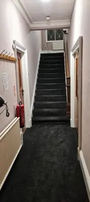 a hallway with a staircase in a building at LSO Guest House in Dumfries