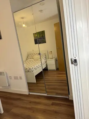 a mirror reflection of a bedroom with a bed in a room at Welcome to Home Away From home in Moffat
