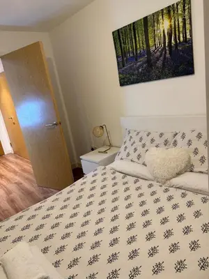 a bedroom with a bed with a white comforter at Welcome to Home Away From home in Moffat