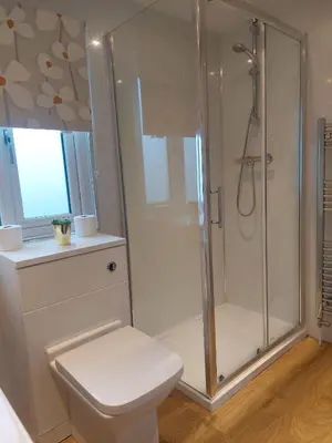 a white bathroom with a shower and a toilet at Stunning Sea View - Farm Stay - Kilchoman 9 in Stranraer