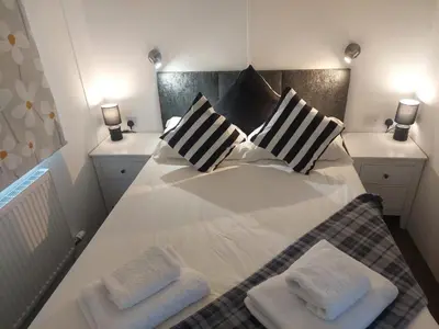 a bedroom with a bed with two pillows on it at Stunning Sea View - Farm Stay - Kilchoman 9 in Stranraer
