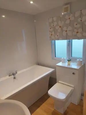 a bathroom with a tub and a toilet and a sink at Stunning Sea View - Farm Stay - Kilchoman 9 in Stranraer