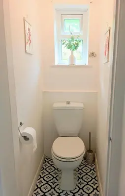 a bathroom with a white toilet and a window at Catbells Sunrise Cottage Borrowdale Lake District in Keswick