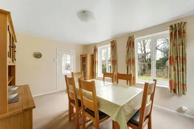 a kitchen and dining room with a table and chairs at Burnmoor in Keswick