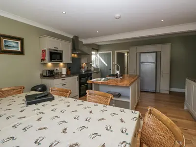 a kitchen and dining room with a table and chairs at Osprey Cottage in Ambleside