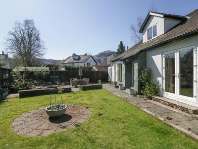 a yard with a pot on the grass at Osprey Cottage in Ambleside