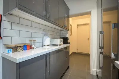a kitchen with a counter top and a refrigerator at Moss Crag in Penrith