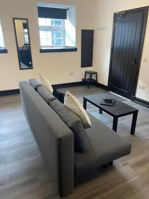 a living room with a couch and a coffee table at GlasVenn Cottages in Irvine
