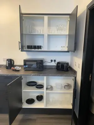 a kitchen with a counter with a microwave at GlasVenn Cottages in Irvine