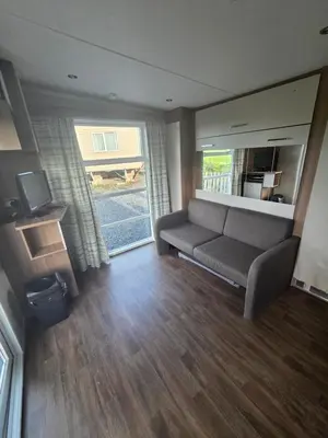 a living room with a couch and a television at The View in Ballantrae