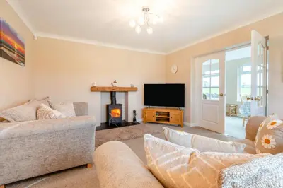 a living room with two couches and a flat screen tv at 3 Bed in Aspatria oc-w31951 in Hayton