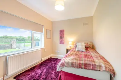 a bedroom with a bed and a large window at 3 Bed in Aspatria oc-w31951 in Hayton