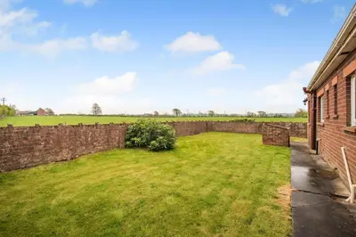 an image of a yard next to a brick wall at 3 Bed in Aspatria oc-w31951 in Hayton