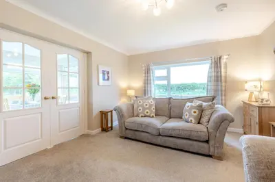 a living room with a couch and a window at 3 Bed in Aspatria oc-w31951 in Hayton