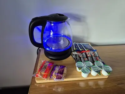 a table with a blue mug and some cookies and candy at Manesty House - Rooms only - no kitchen-living in Keswick