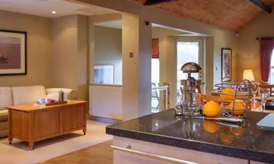 a kitchen and living room with a counter with oranges on it at Robinson in Keswick