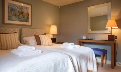 a hotel room with a bed with towels on it at Robinson in Keswick