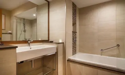 a bathroom with a sink and a bath tub at Robinson in Keswick