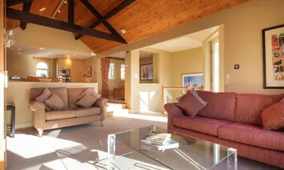 a living room with two couches and a glass table at Robinson in Keswick