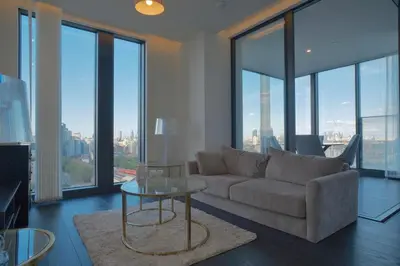 a living room with a couch and a glass table at 2b2b skyline flat&amazing view! in Moffat