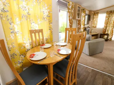 a wooden table with chairs and a dining room at Cates Cozy Cabin in Carlisle