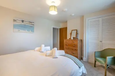 a bedroom with a large white bed and a dresser at 2 Bed in Allonby oc-i30743 in Allonby