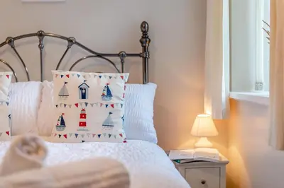 a bedroom with a bed with a pillow and a lamp at 2 Bed in Allonby oc-i30743 in Allonby