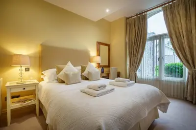 a bedroom with a large bed with towels on it at Derwent in Keswick