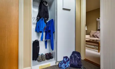 a walk in closet with shoes and a mirror at Derwent in Keswick