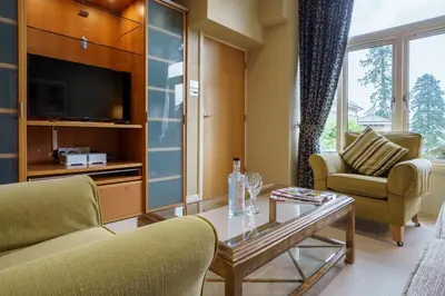 a living room with a tv and a coffee table at Derwent in Keswick