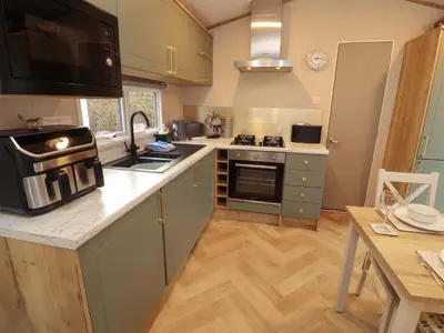 a kitchen with a stove and a counter top at Seren in Cockermouth