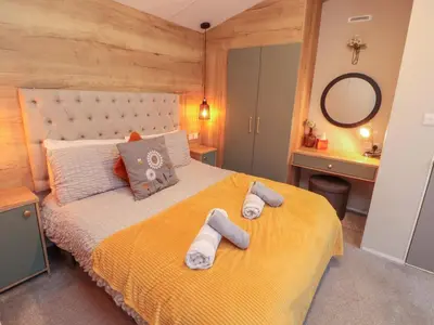 a bedroom with a bed with towels on it at Seren in Cockermouth