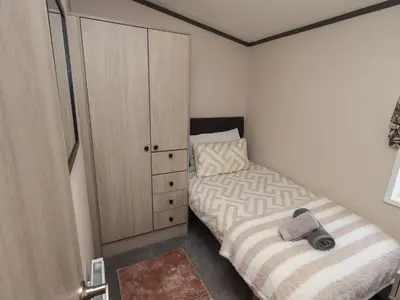 a small bedroom with a bed and a closet at Haven in Cockermouth