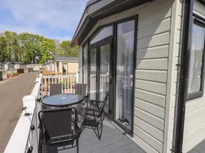 a balcony with a table and chairs on a house at Haven in Cockermouth