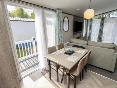 a dining room with a table and a couch at Haven in Cockermouth