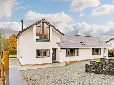 a white house with a black roof at 3 Bed in Keswick oc-93589 in Threlkeld