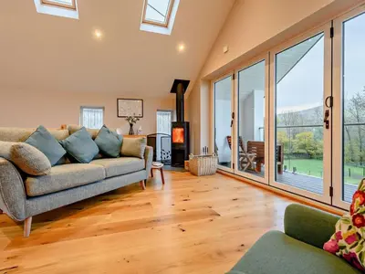 a living room with a couch and large windows at 3 Bed in Keswick oc-93589 in Threlkeld