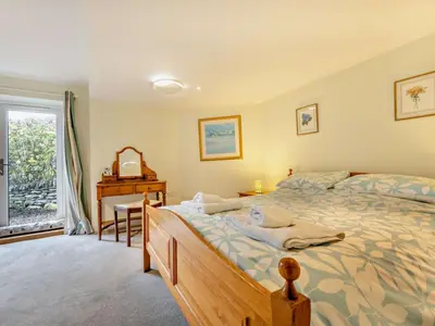 a bedroom with a bed and a desk and a window at 3 Bed in Keswick oc-93590 in Threlkeld