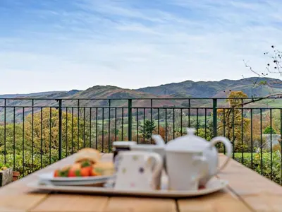 a table with a plate of food and a cup of tea at 3 Bed in Keswick oc-93590 in Threlkeld