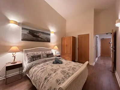 a bedroom with a large bed and two night stands at Marina 2bedroom Beach Nearby Swansea City in Moffat