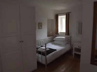 a small bedroom with a bed and a window at The Old Dairy in Lochfoot