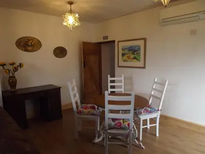 a living room with a table and chairs and a dining room at The Old Dairy in Lochfoot