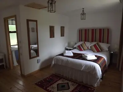 a hotel room with a bed and a mirror at The Old Dairy in Lochfoot