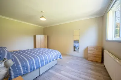 a bedroom with a bed and a window at The Stables Cottage, Beattock, Moffat in Beattock