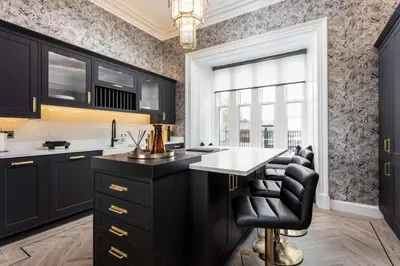 a kitchen with a black island and black cabinets at No36 South Beach - Donnini Apartments in Troon