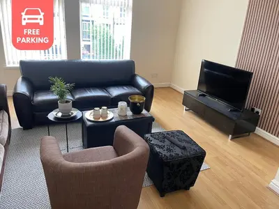 a living room with a couch and a tv at New Stylish Large 1-Bed Apartment - Close to Old Trafford & More in Moffat