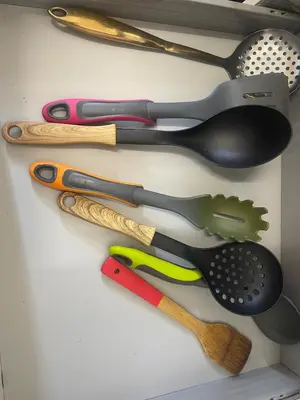 a group of kitchen utensils hanging on a wall at New Stylish Large 1-Bed Apartment - Close to Old Trafford & More in Moffat